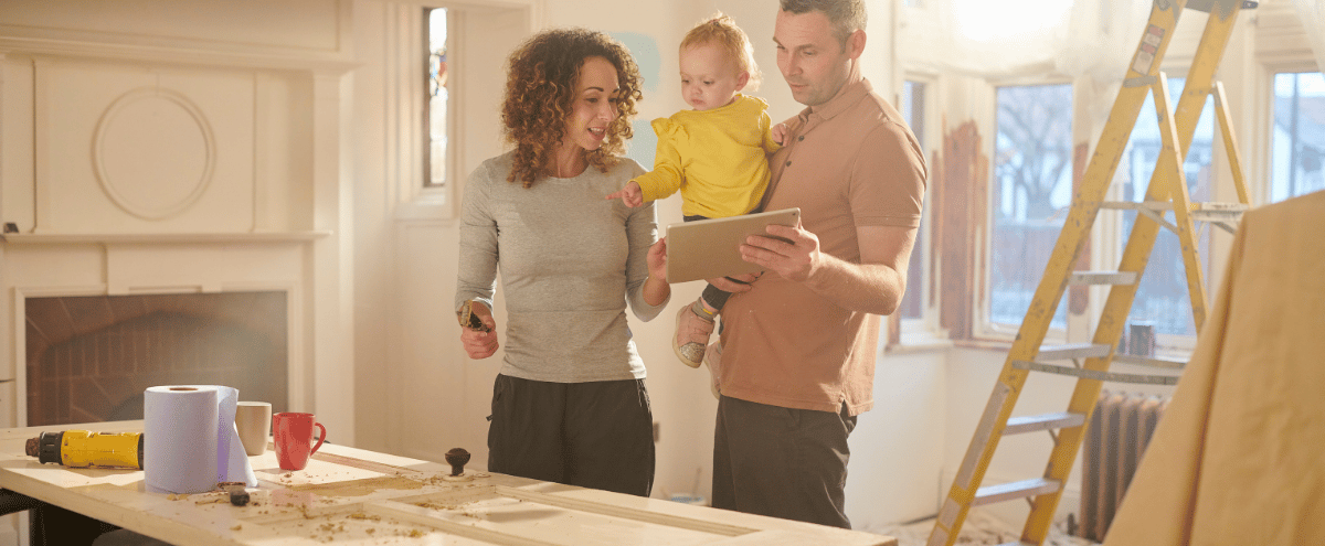 Header image of a family reviewing a home renovation loan. | Direct Mortgage Loans