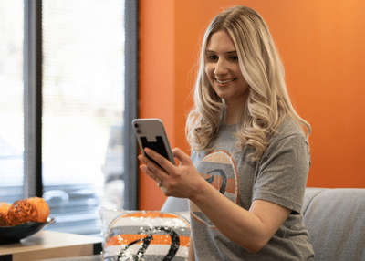 Blonde woman smiling looking at cell phone