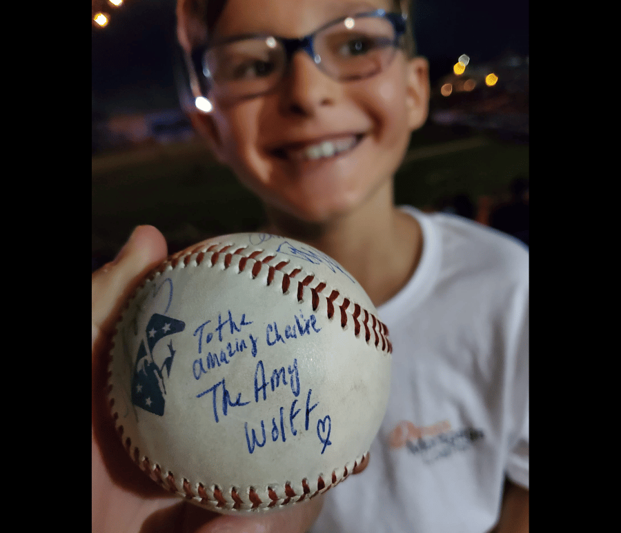 Child with signed baseball