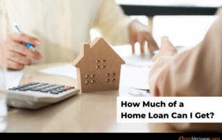 Wooden toy house calculator and a perswon holding a pen and messing with papers on a table.
