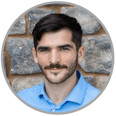 Brown haired male wearing light blue collard shirt